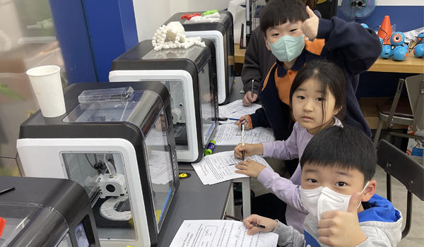 Kids using 3D printers