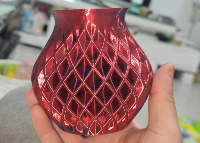 Red 3D printed vase with patterened exterior