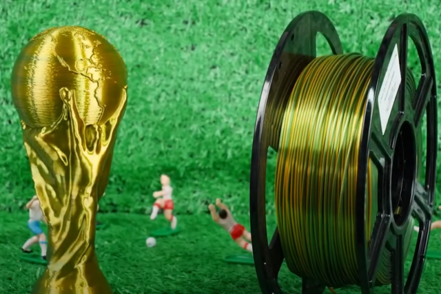 3D printed world cup next to golden 3D printing material spool