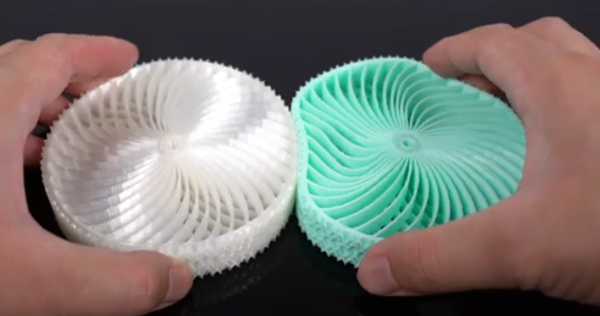 White and green gears 3d printed using different flexible 3D printing materials
