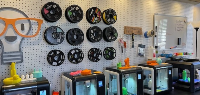 3D printers with different 3D printing material types on wall  